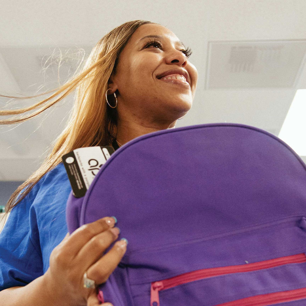 colleague gives backpack