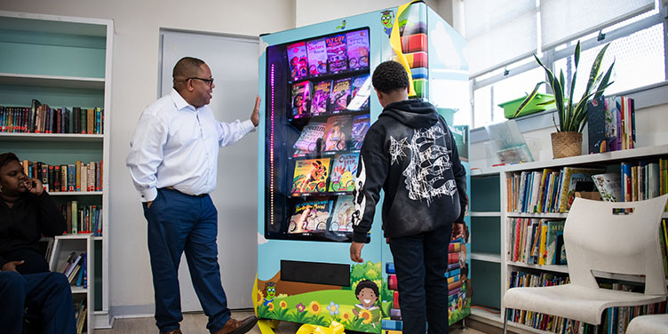 Crete Academy Students Browse Book Vending Machine Donation