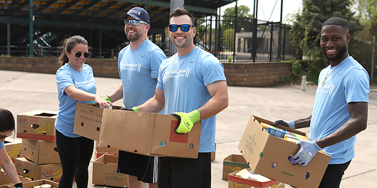 First American Finance volunteers holding food boxes