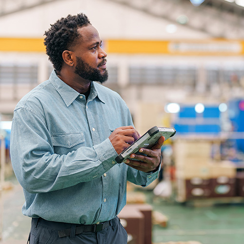 African man using tablet working for checking the product quality of the car interior manufacturing factory. Production quality control process. Auto part manufacturing industry.