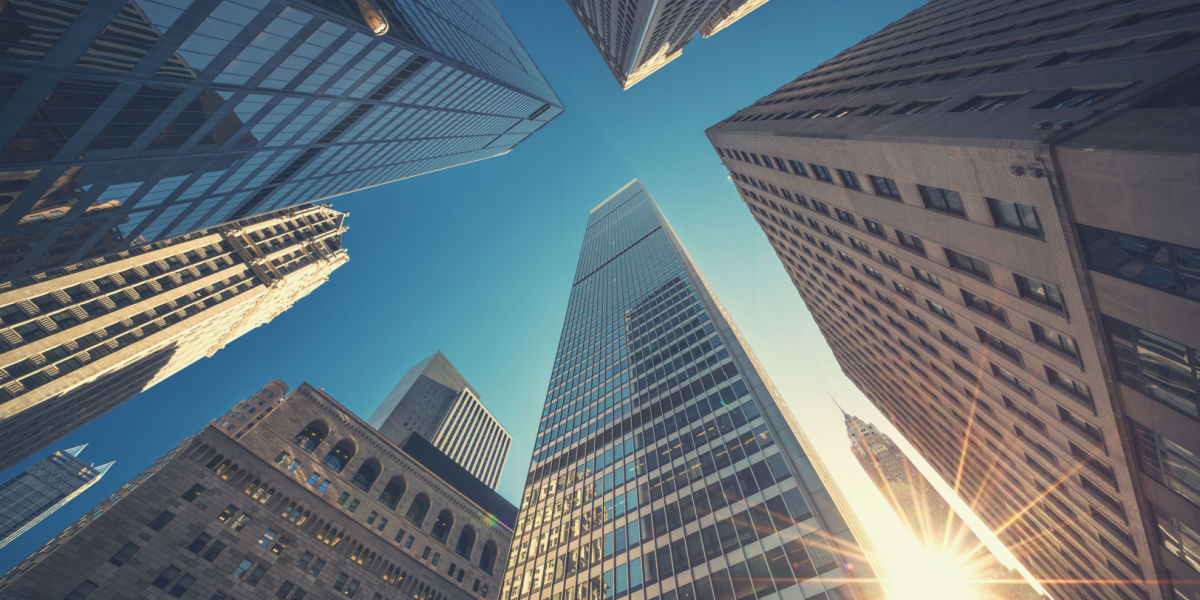 View looking up at towering skyscrapers 