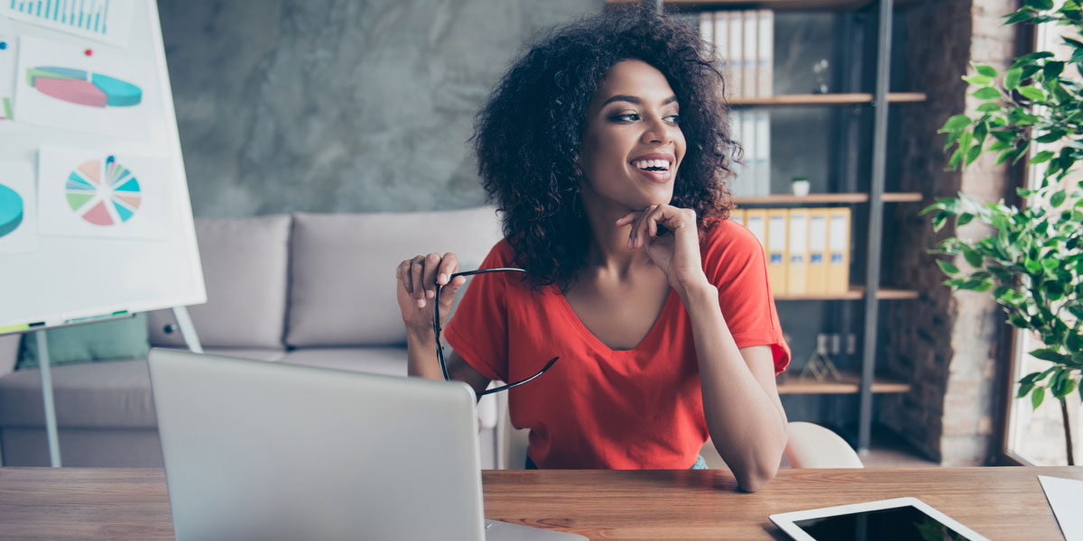 A women looking at laptop thinking about inheriting a business.