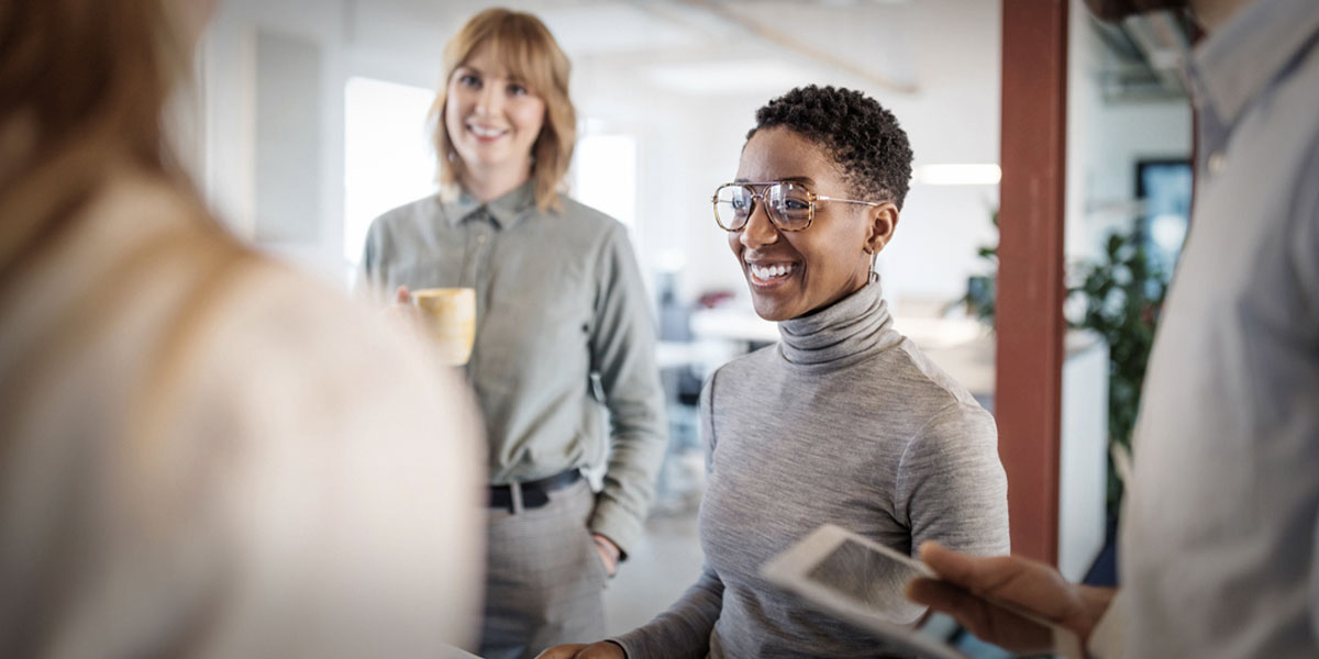 millennial business woman among colleagues