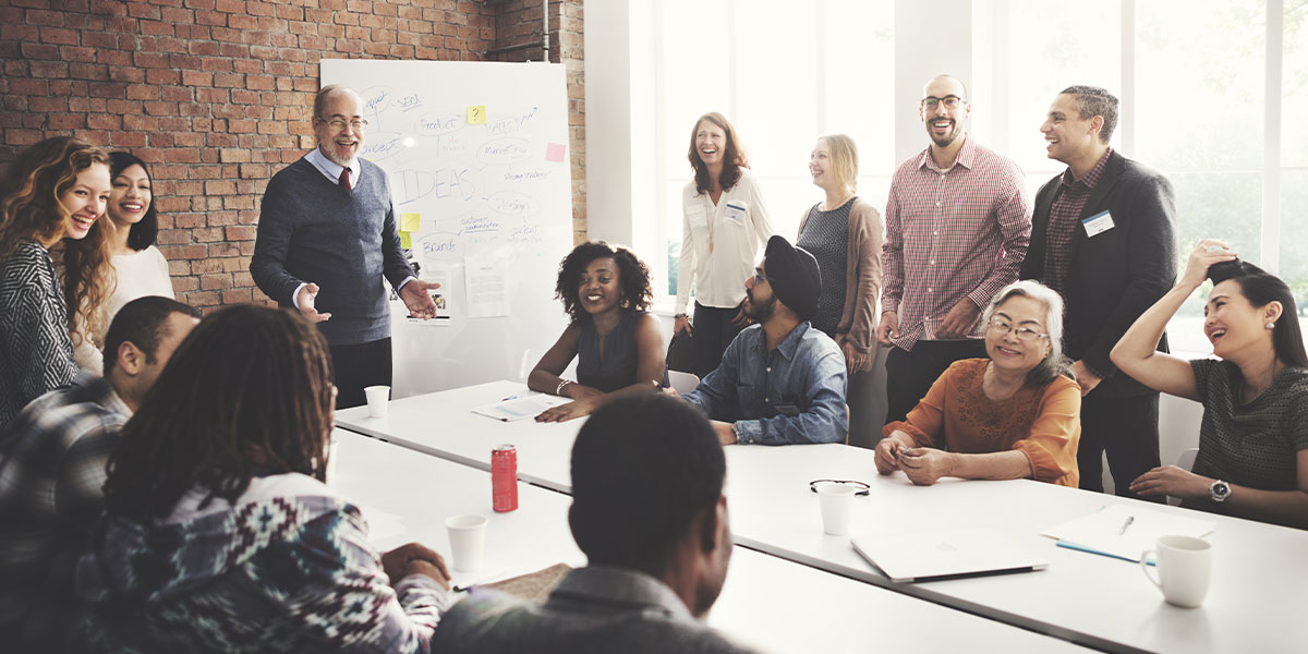 An entrepreneur surrounded by a group of happy employees. 