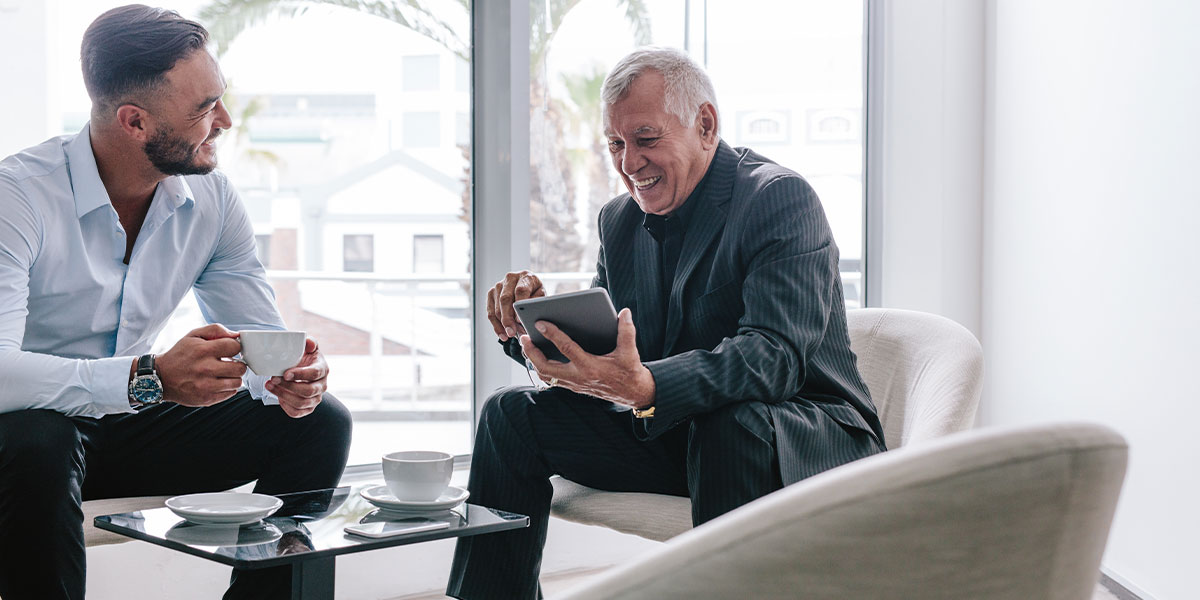 An entrepreneur meets with his business mentor to discuss his strategic plan for growth.