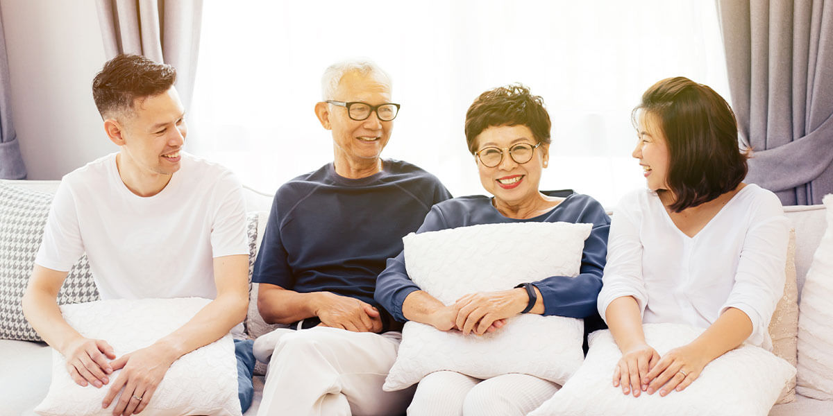 Family sitting on the couch, enjoying each other's company. 