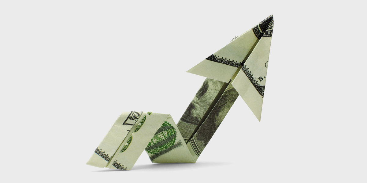 Dollar bill folded to look like an upward trending graph
