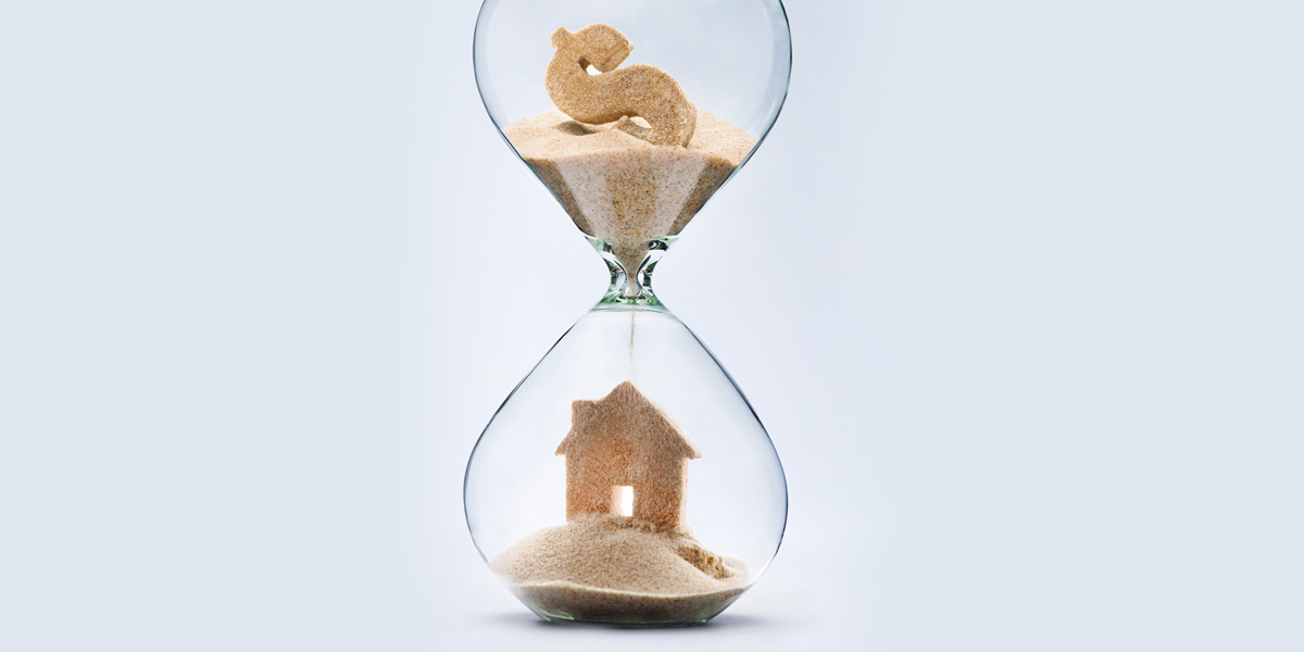 Hourglass showing a dollar sign and home in sand.