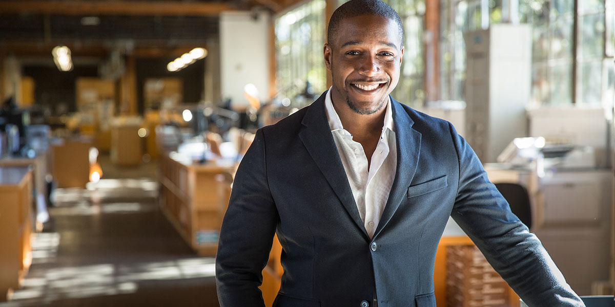 Portrait of a young male professional smiling in an office. 