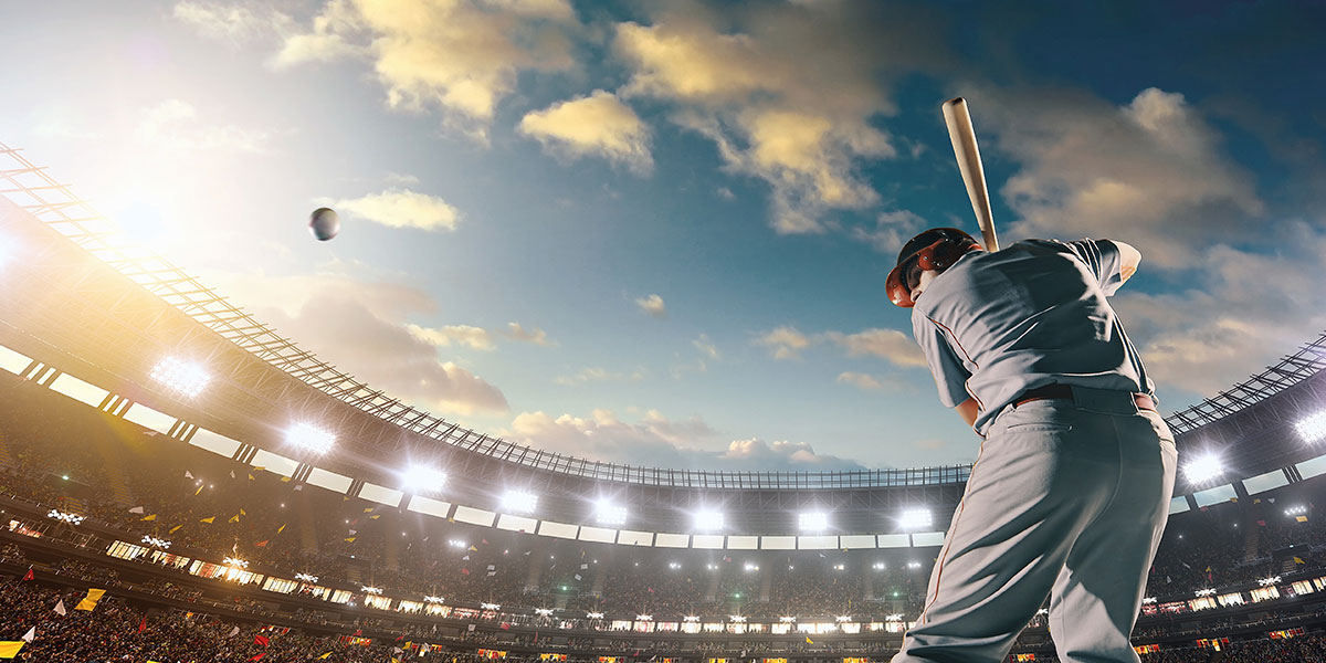 Baseball player swinging at a baseball.