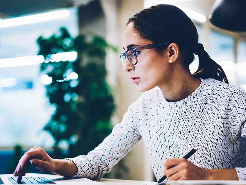 Residential mortgage loan consultant works diligently on her computer for City National Bank 