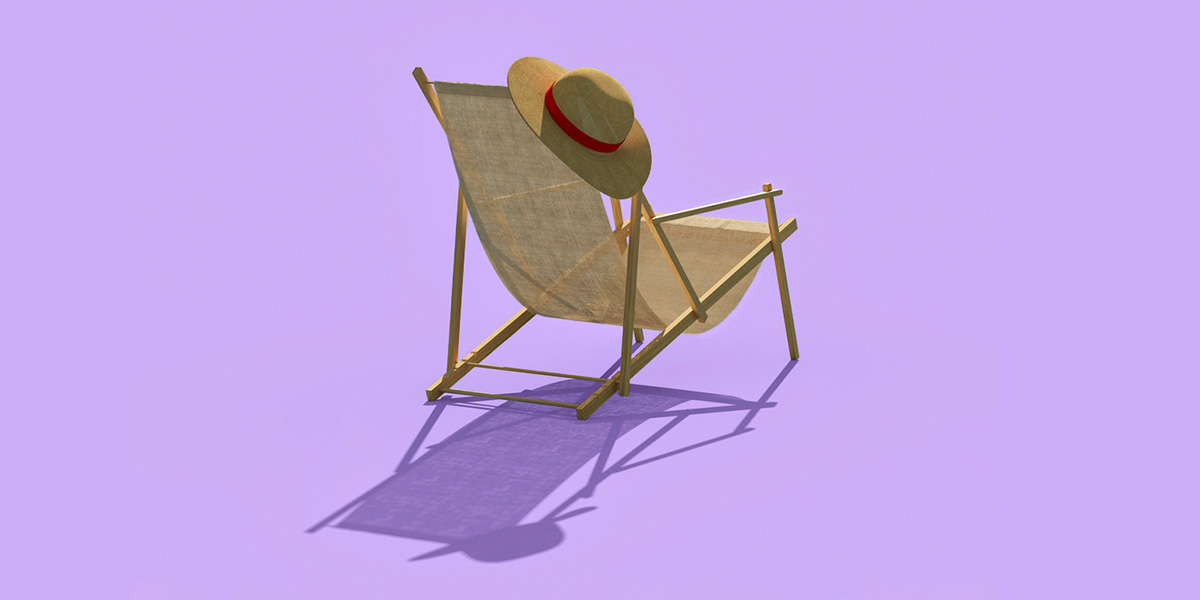 Beach chair with a sun hat hanging on it