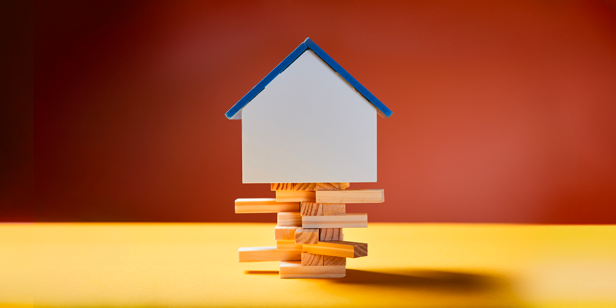 House balancing on Jenga blocks