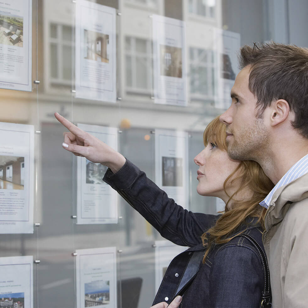 Couple looking at property listings now that they've secured a mortgage loan at City National Bank