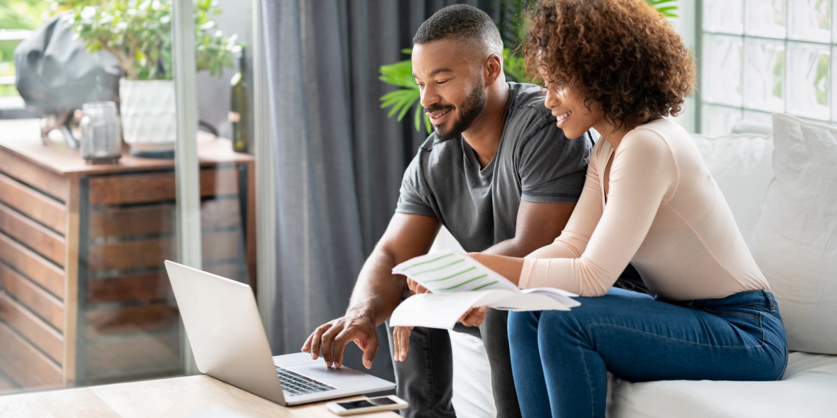 Couple reviewing finances in front a laptop