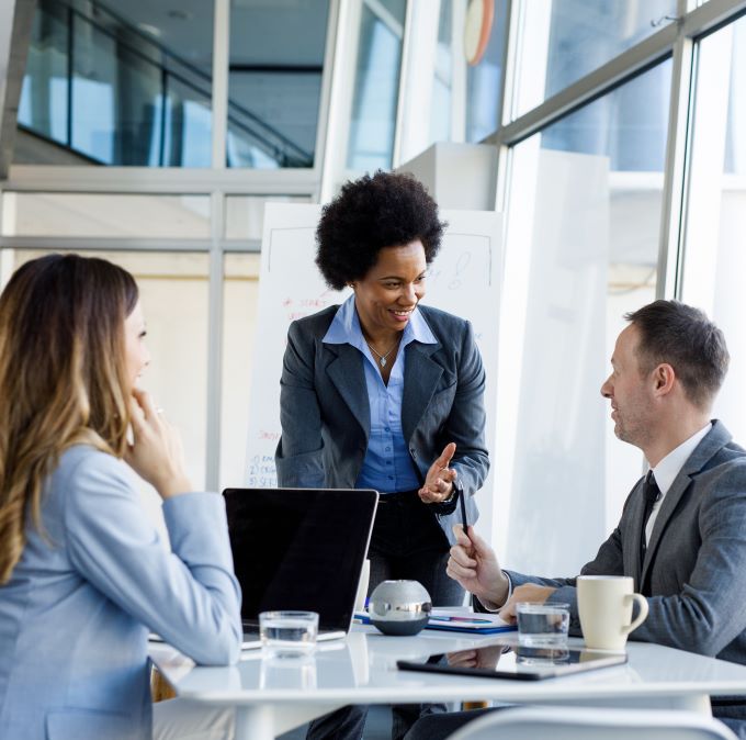 Three banking specialists talk in a conference room