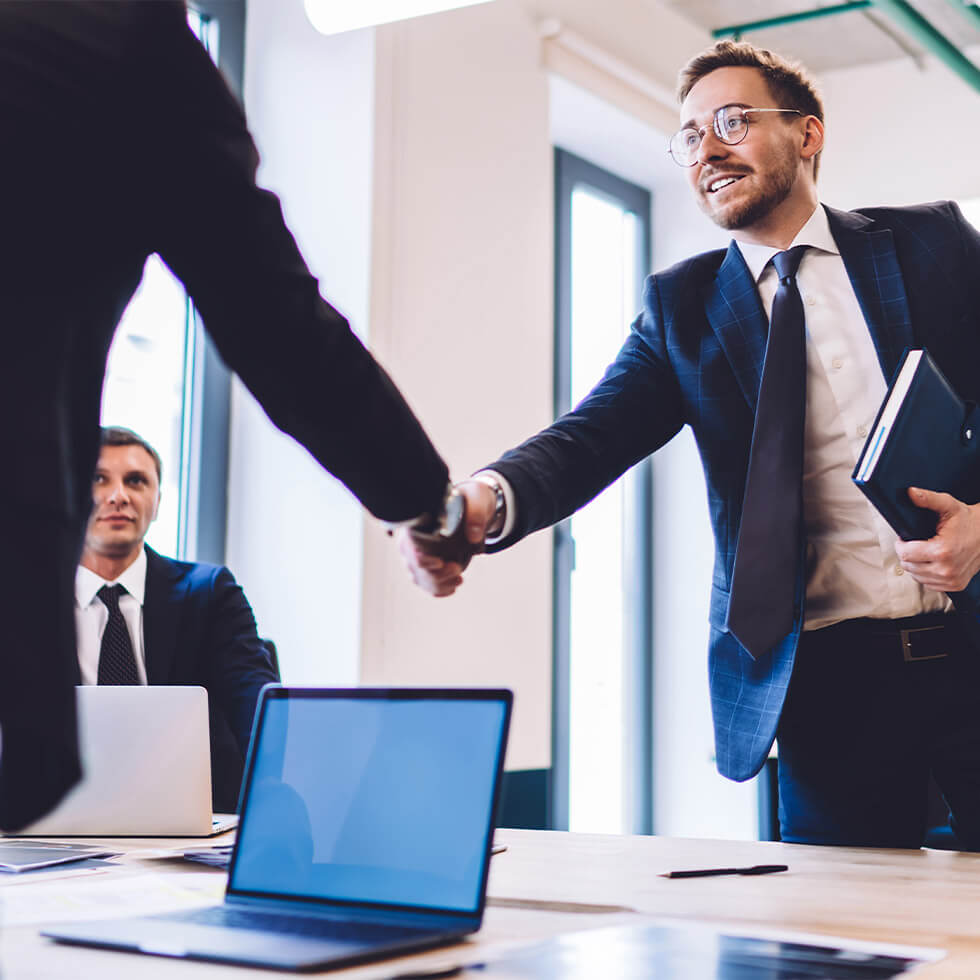 City National Bank Advisor shakes hands with client after finalizing portfolio management strategy