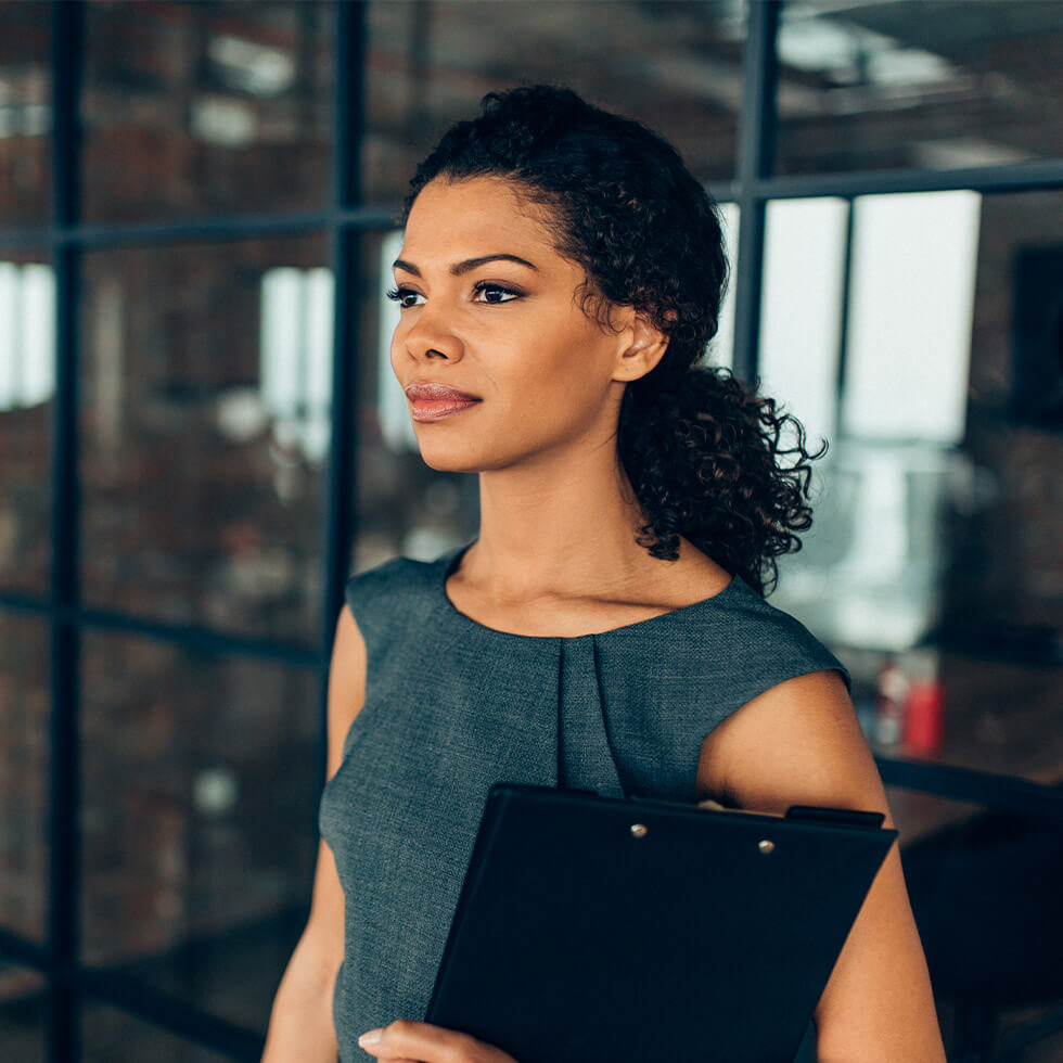 Woman holding clip board binder