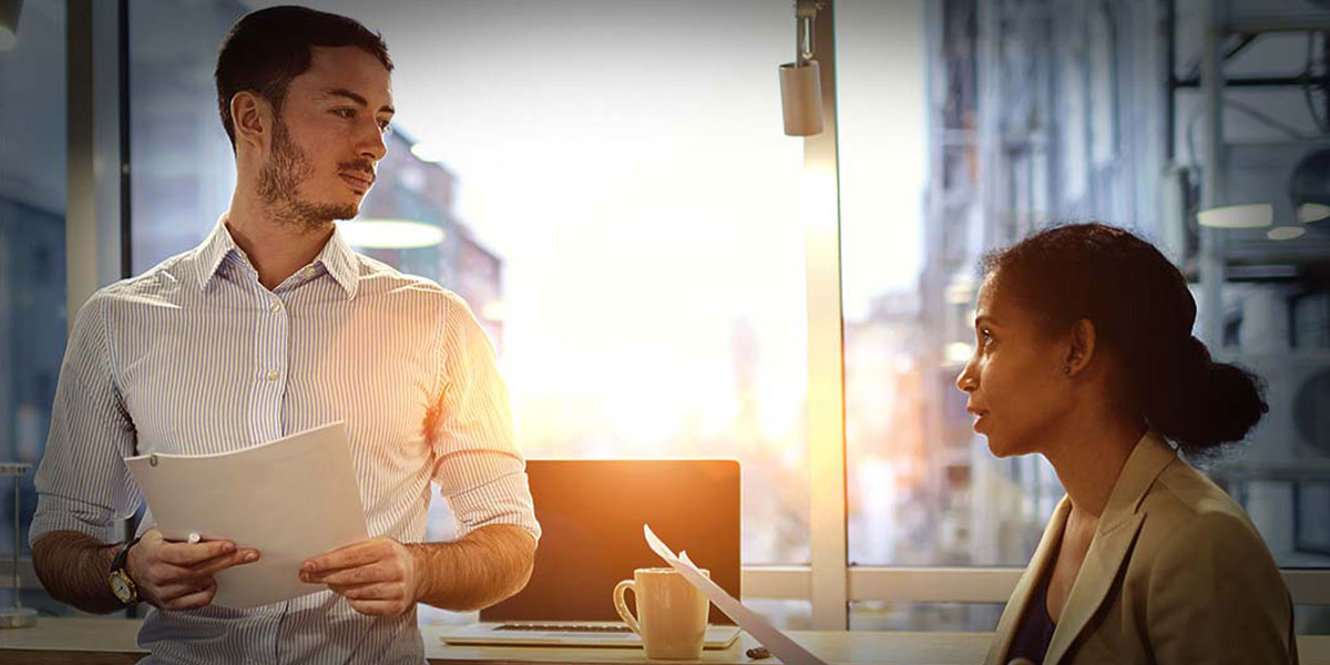 Two entrepreneurs review their business partnership agreement to ensure they're protecting the business. 